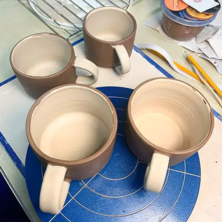 4 mugs with slip
