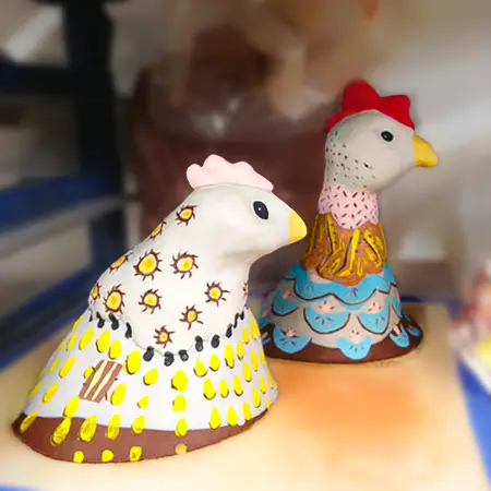Drying on the shelf, Dot (L) and Jenny (R) after being painted with underglazes.