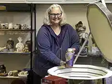 Rebecca In Studio Holding Ceramic Vase