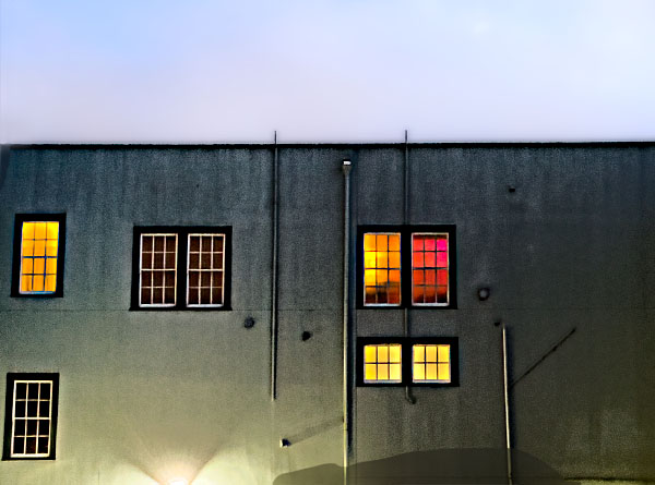 Windows In Deep Colors - Photograph of building wall and colorful window lights against dark blue skies