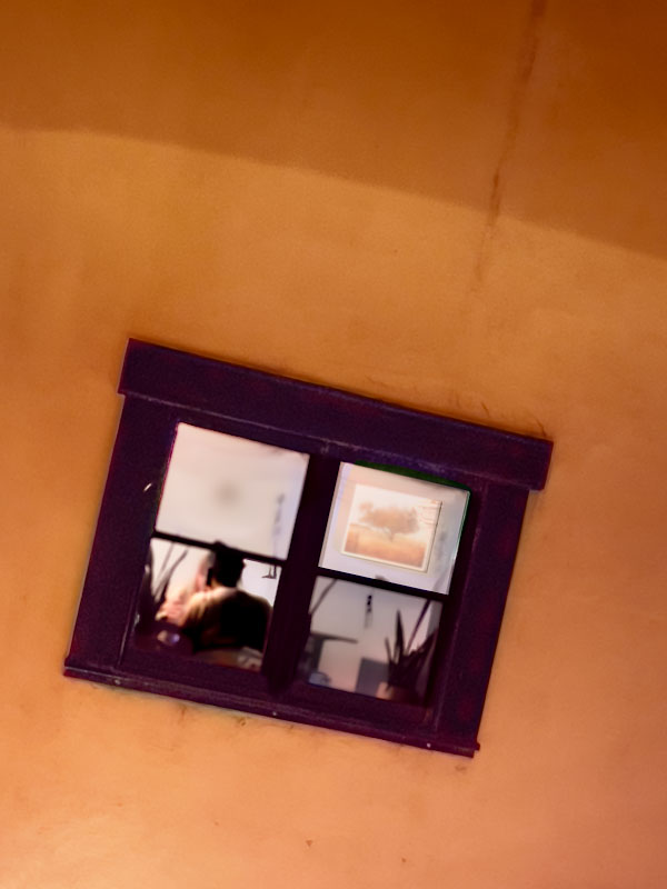 View Inside - Photograph of two diners through a restaurant window